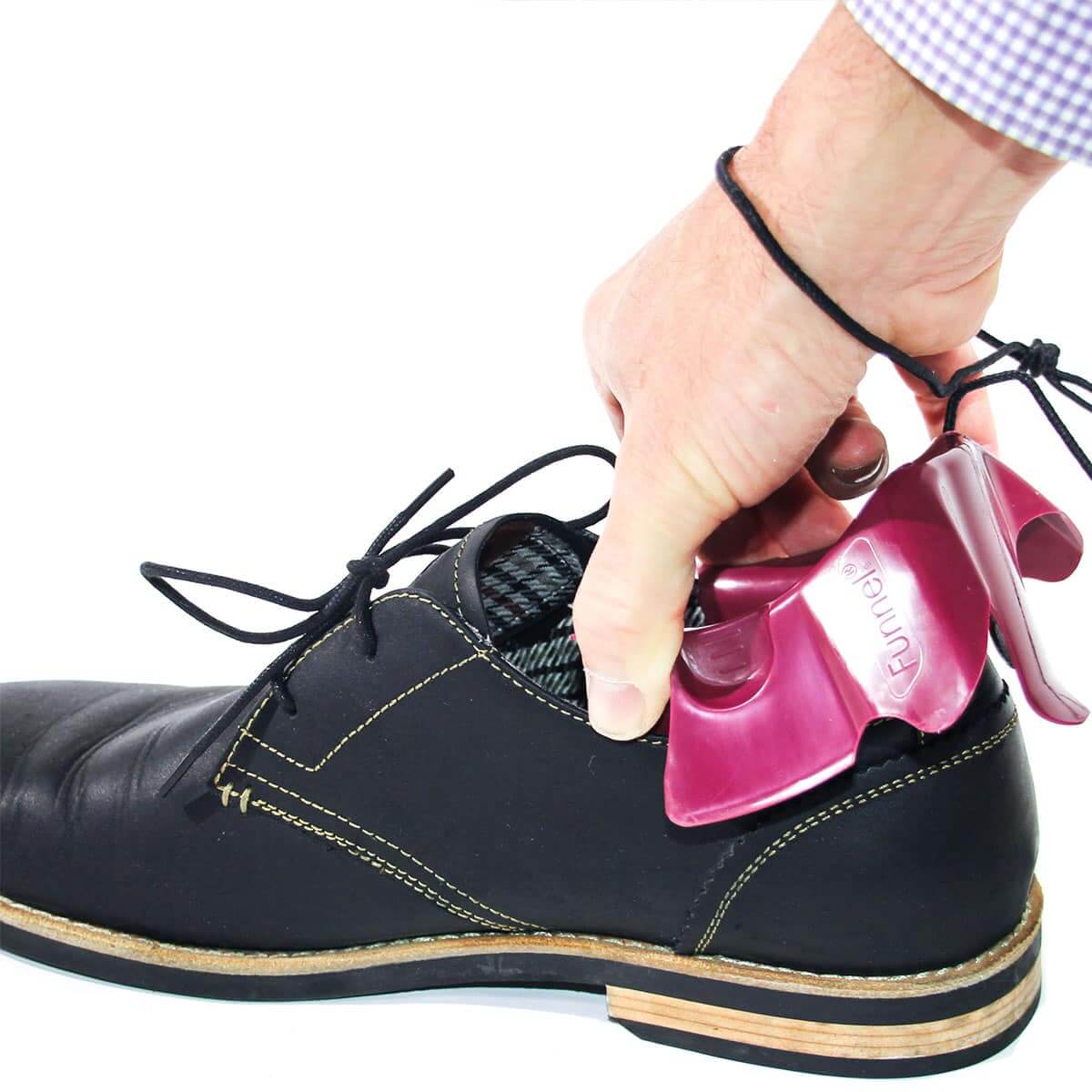 A man's hand placing the foot funnel in a shoe